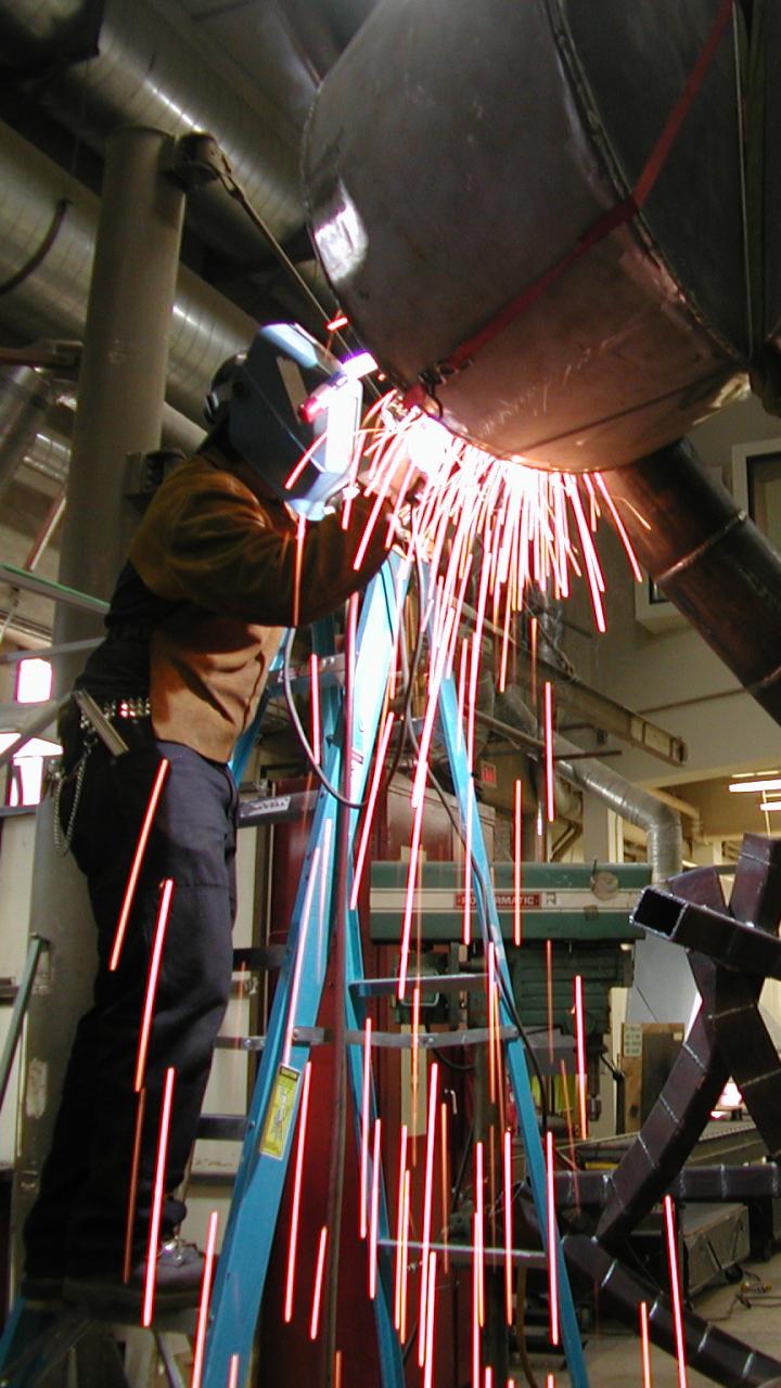 Person welding their sculpture