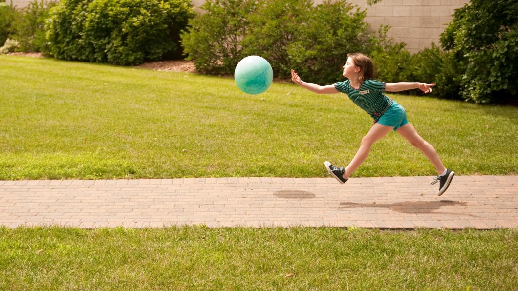 Kid playing with a ball
