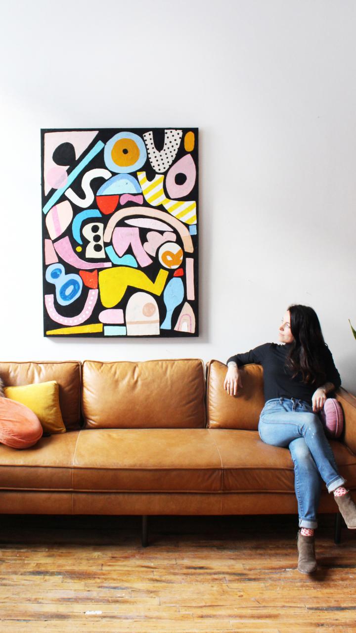 Portrait of Ashley Mary with one of her paintings