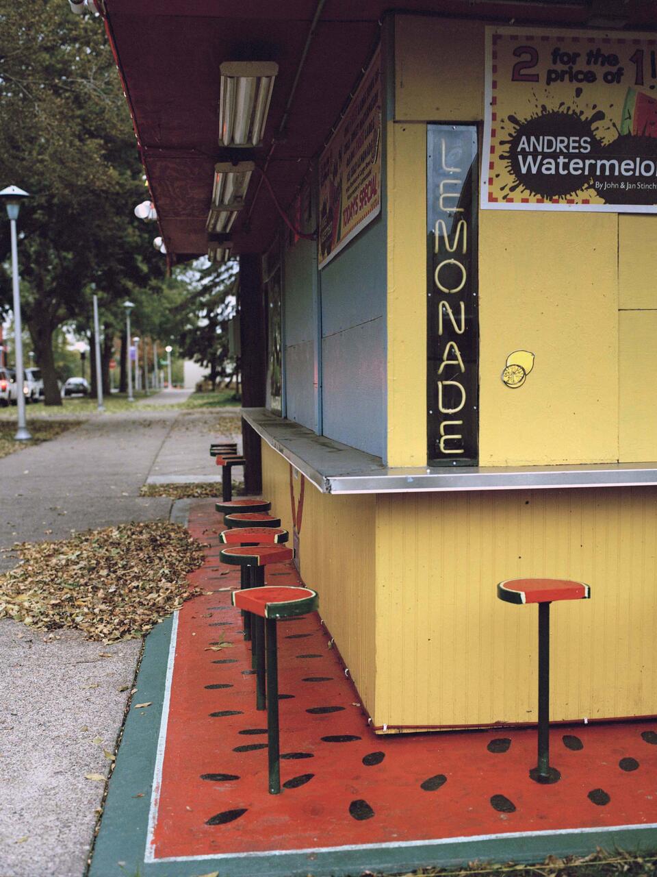 Colorful photograph of a deserted fair shack in the fall.