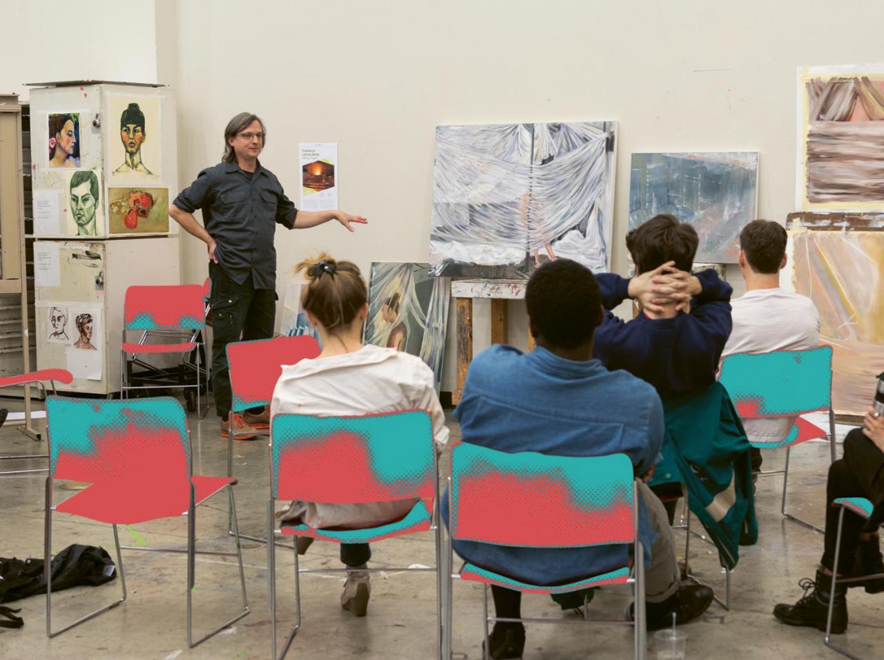 A class critique with an MCAD professor conducting at the front of the room.