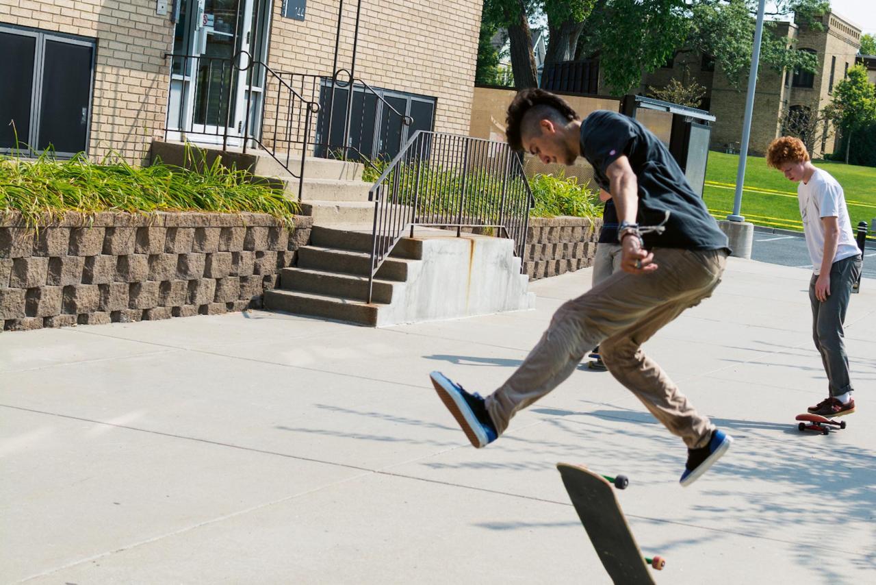 Students skateboarding in front of MCAD's apartment-style dorms.