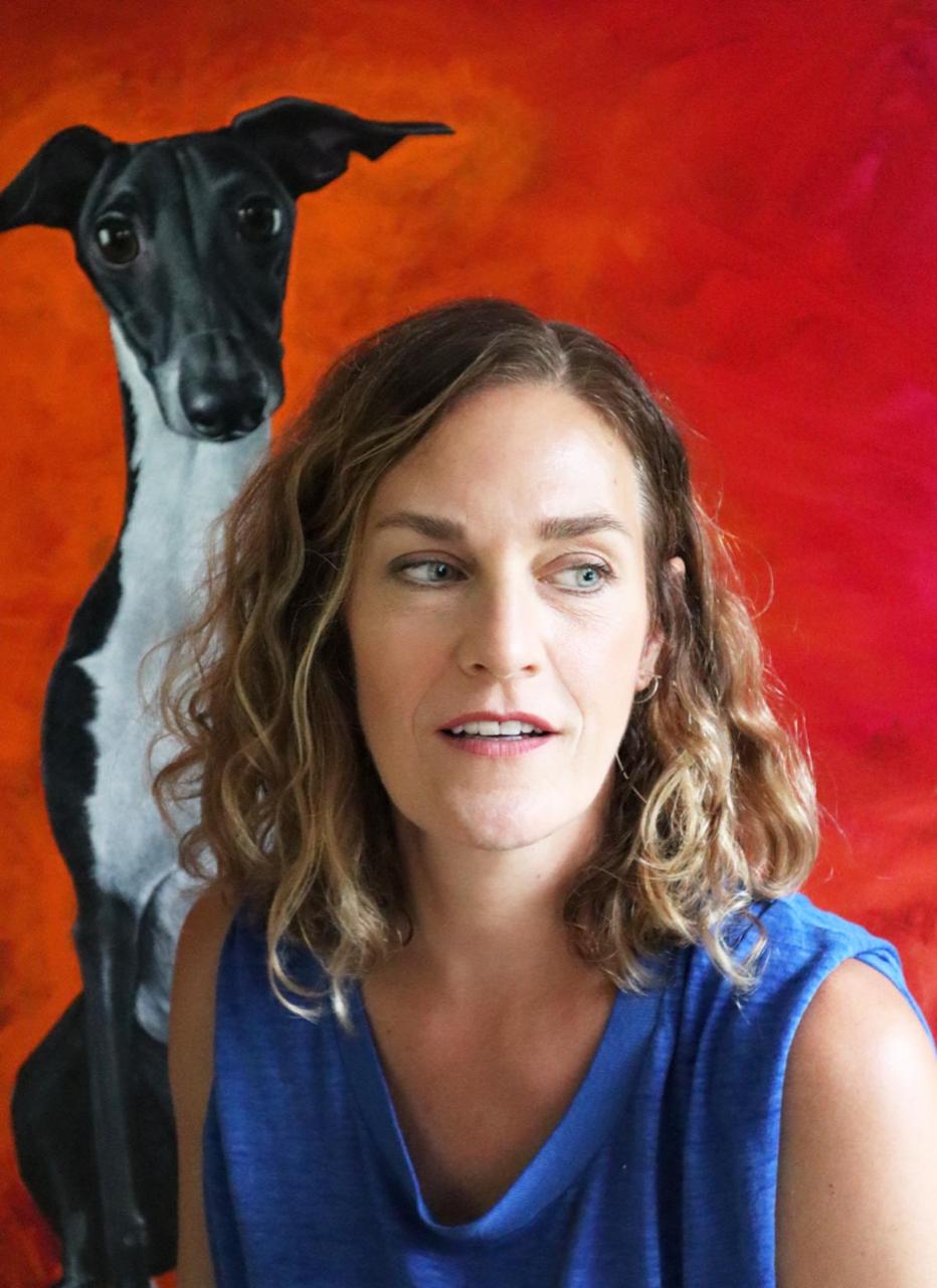Jane Nicolo in front of a dog painting