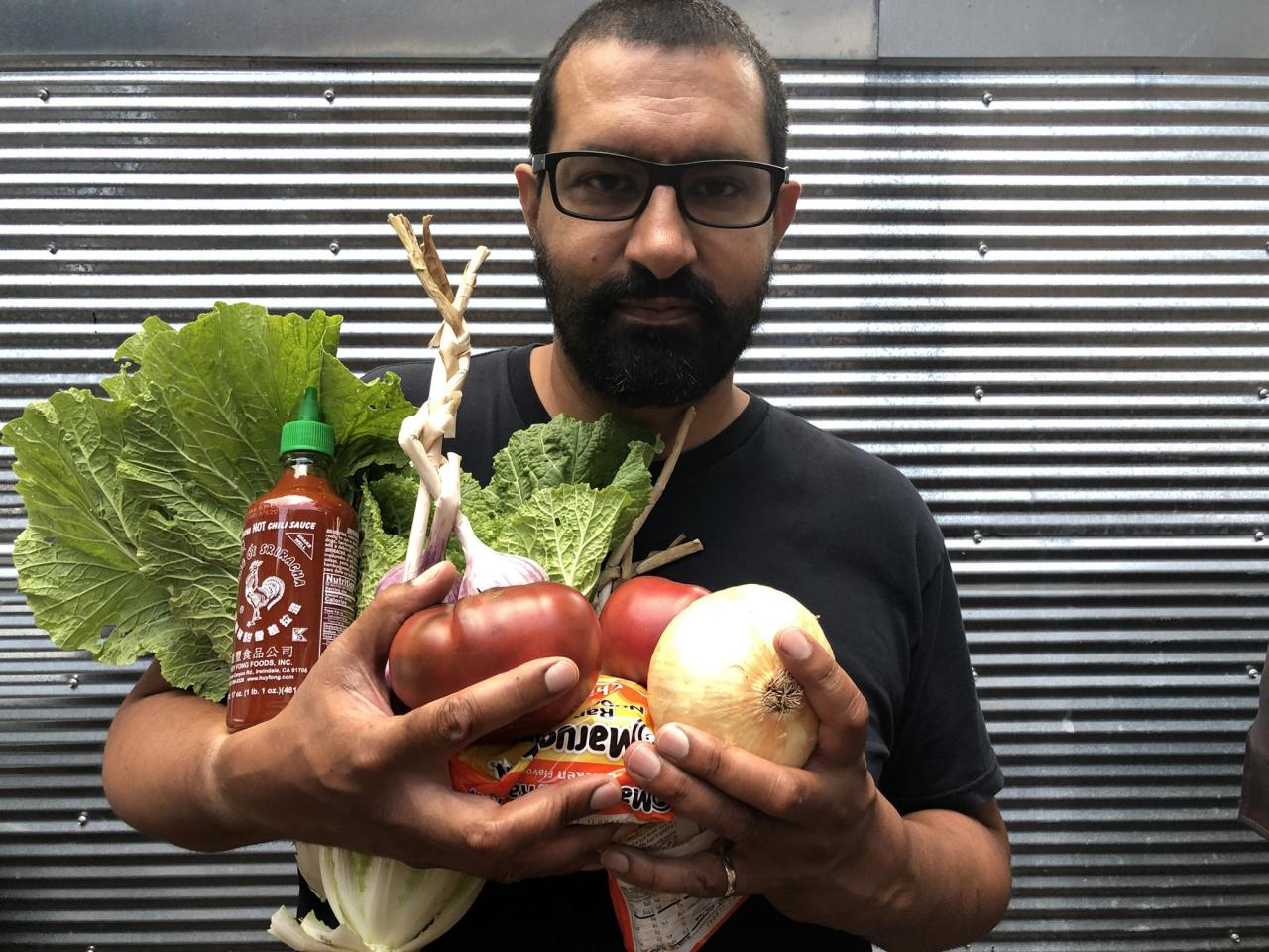 President Sanjit Sethi holding fresh ingredients for his "Souped Up Ramen."