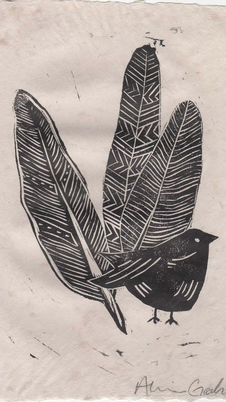 Linocut print of a bird and three feathers on handmade paper.