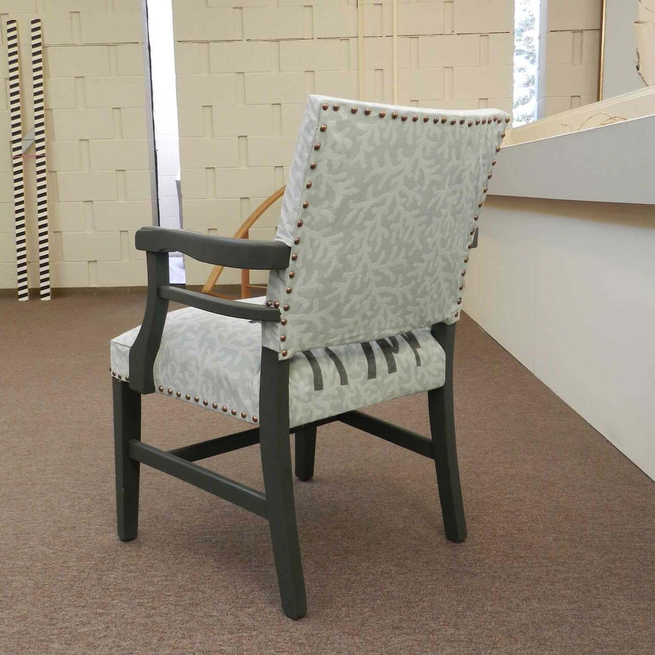 Screen printed fabric of grey and white on reupholstered chair. 