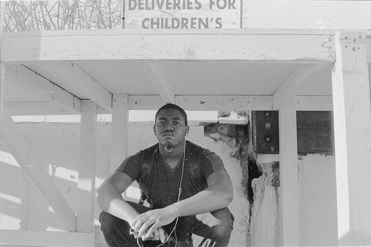 Grayscale photography series featuring single figures in different urban environments.