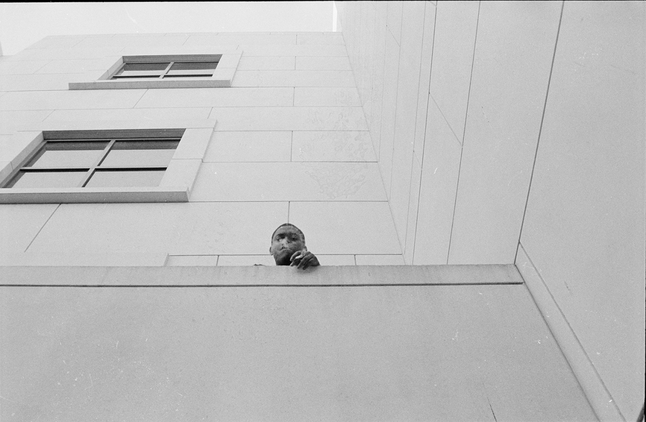 Grayscale photography series featuring single figures in different urban environments.