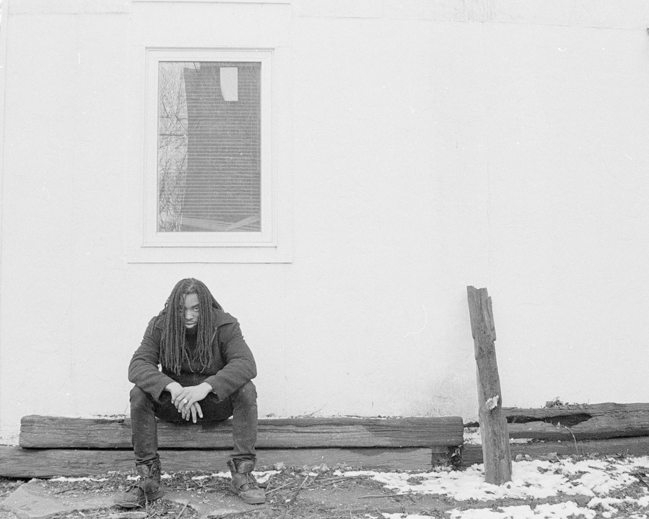 Grayscale photography series featuring single figures in different urban environments.