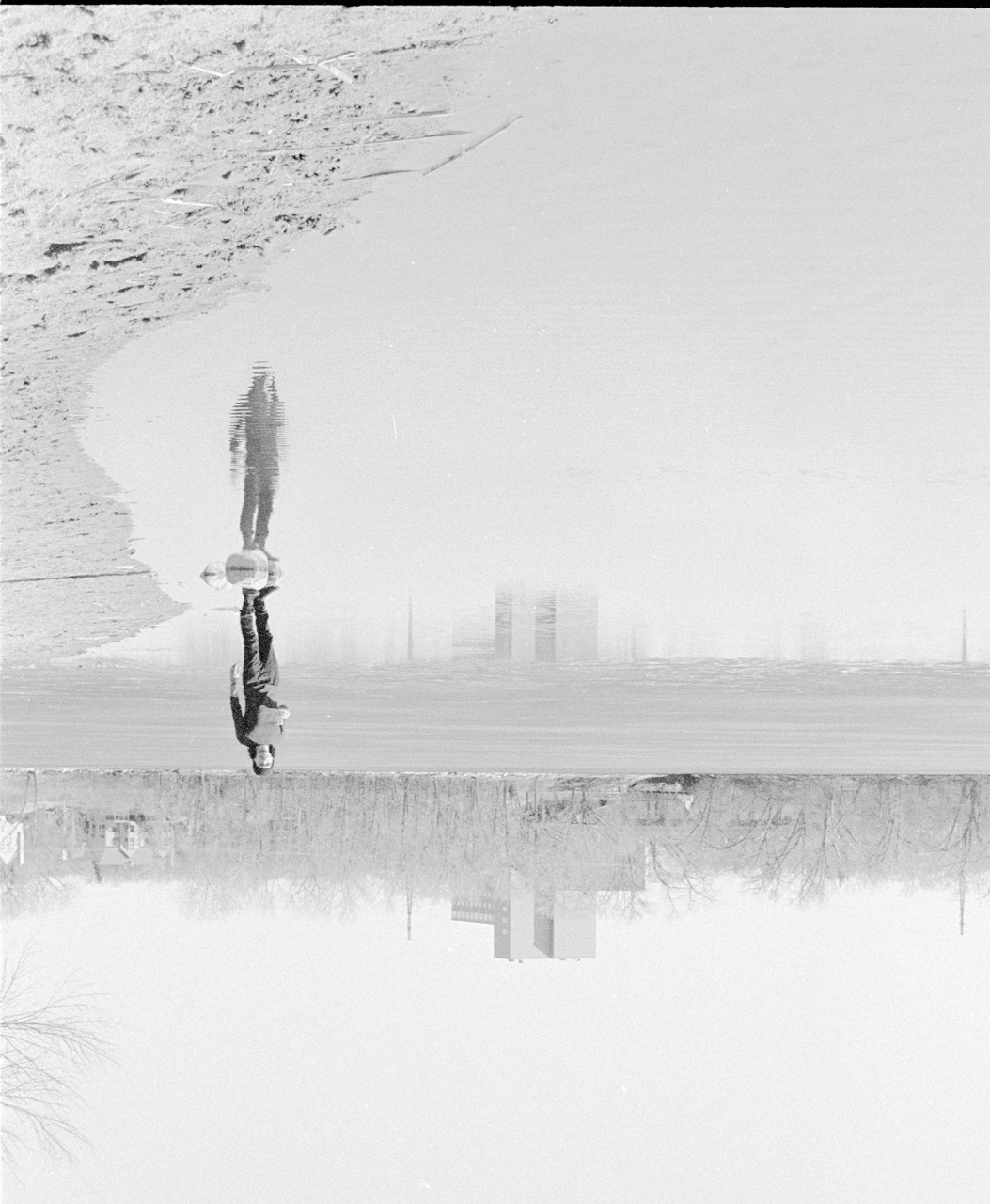 Grayscale photography series featuring single figures in different urban environments.