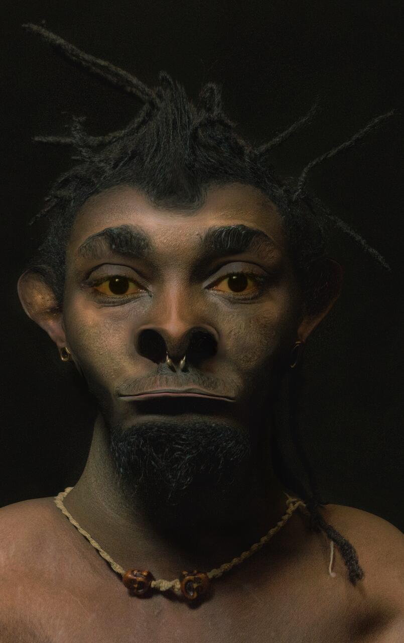 A dramatically lit portrait with the figure showing intense but sincere eye contact with the viewer. 