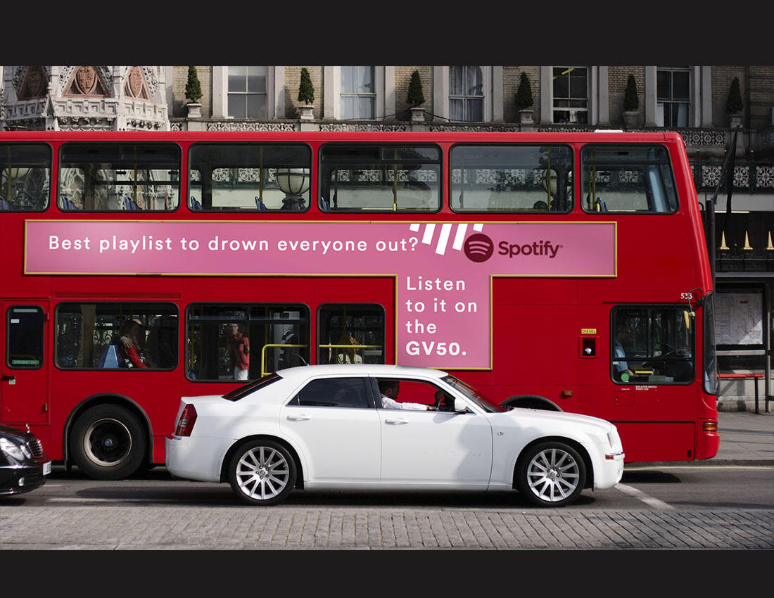 Bus, wall, and poster advertisements for Spotify's viral top 50 playlist.