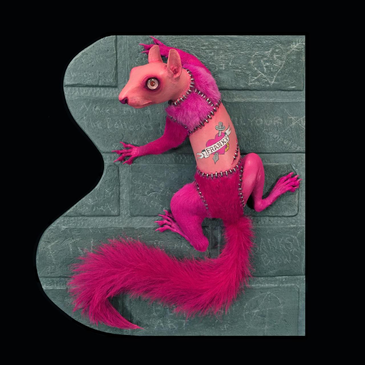 A pink squirrel on the wall