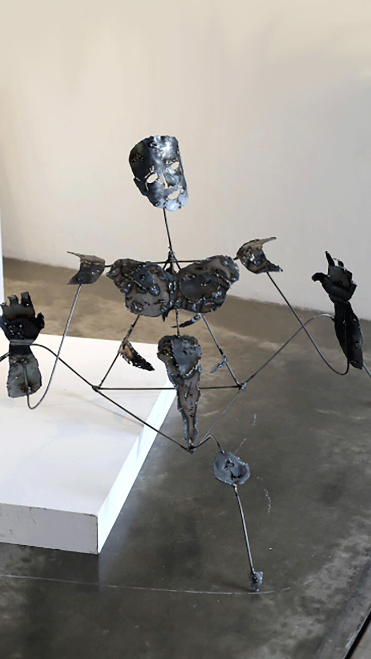Steel sculpture of deconstructed figure.