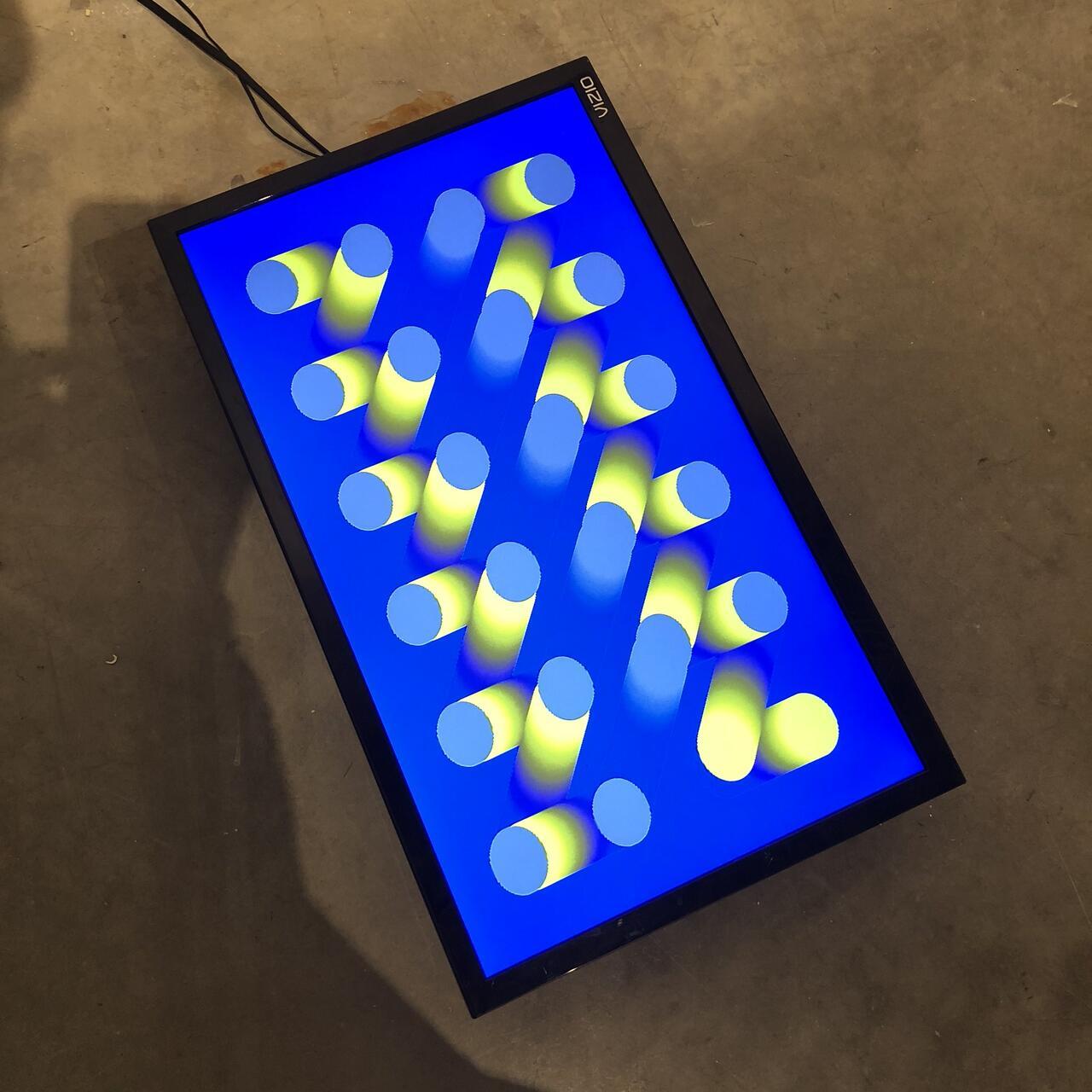 Image on a tablet of geometric shapes and fluorescent blues and yellows