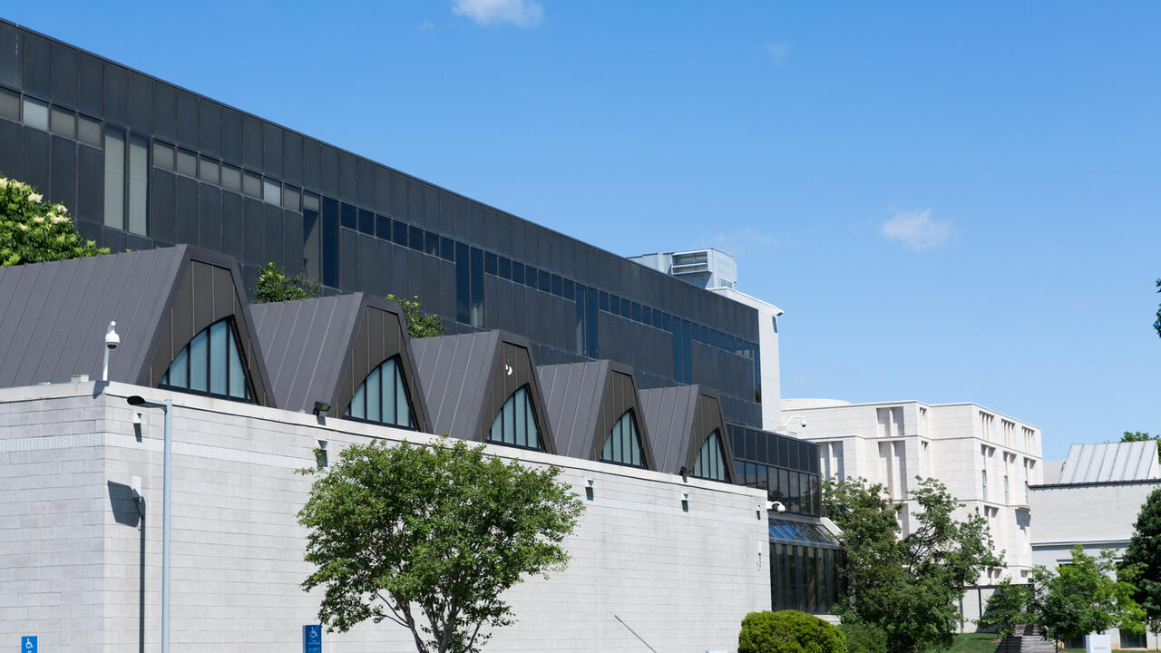 Minneapolis College of Art and Design campus in the summer with blue clear sky and showing the side of grey building