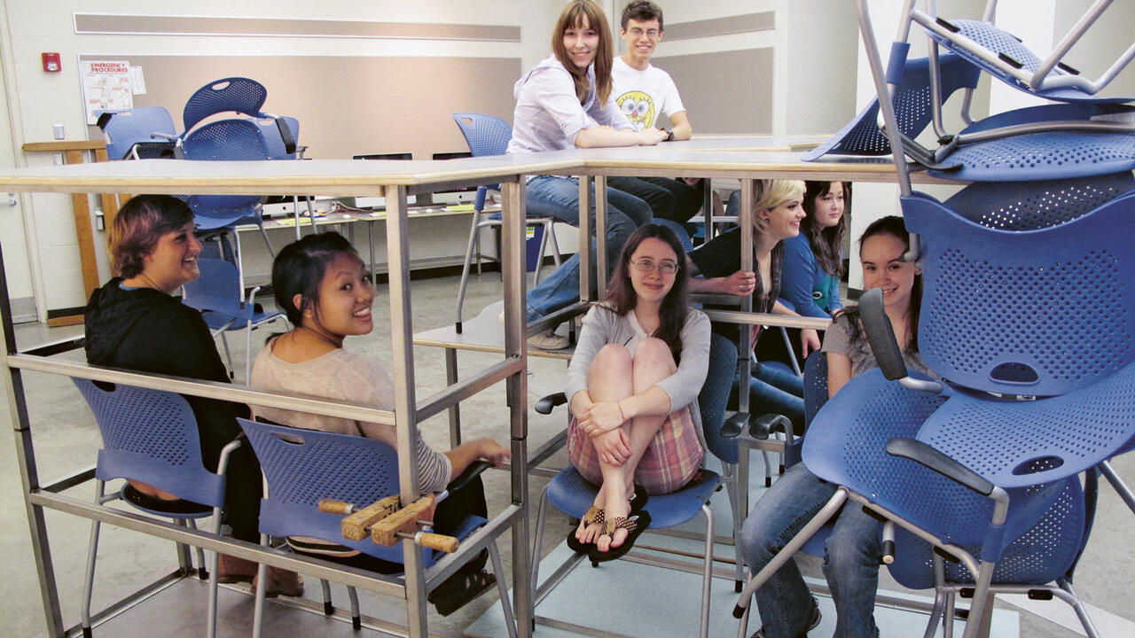 MCAD students in stacked chairs