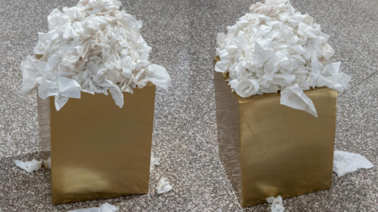 Golden pedestal covered in used tissues