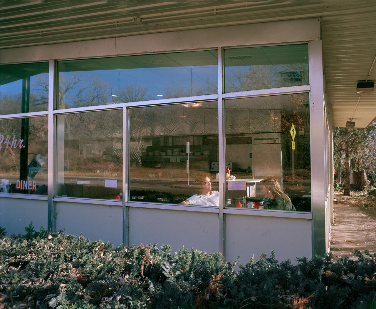 Photograph of people eating in a diner