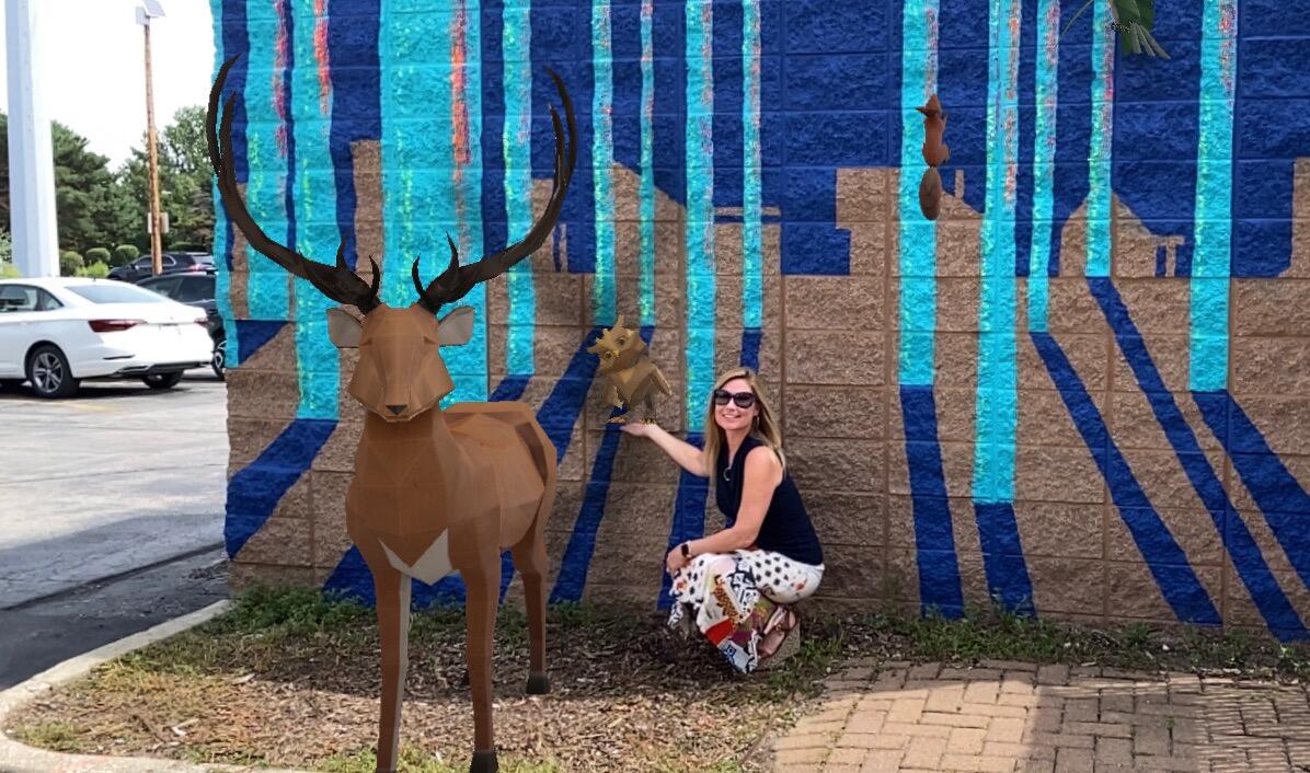 Tamera McLean standing in front of an AR mural