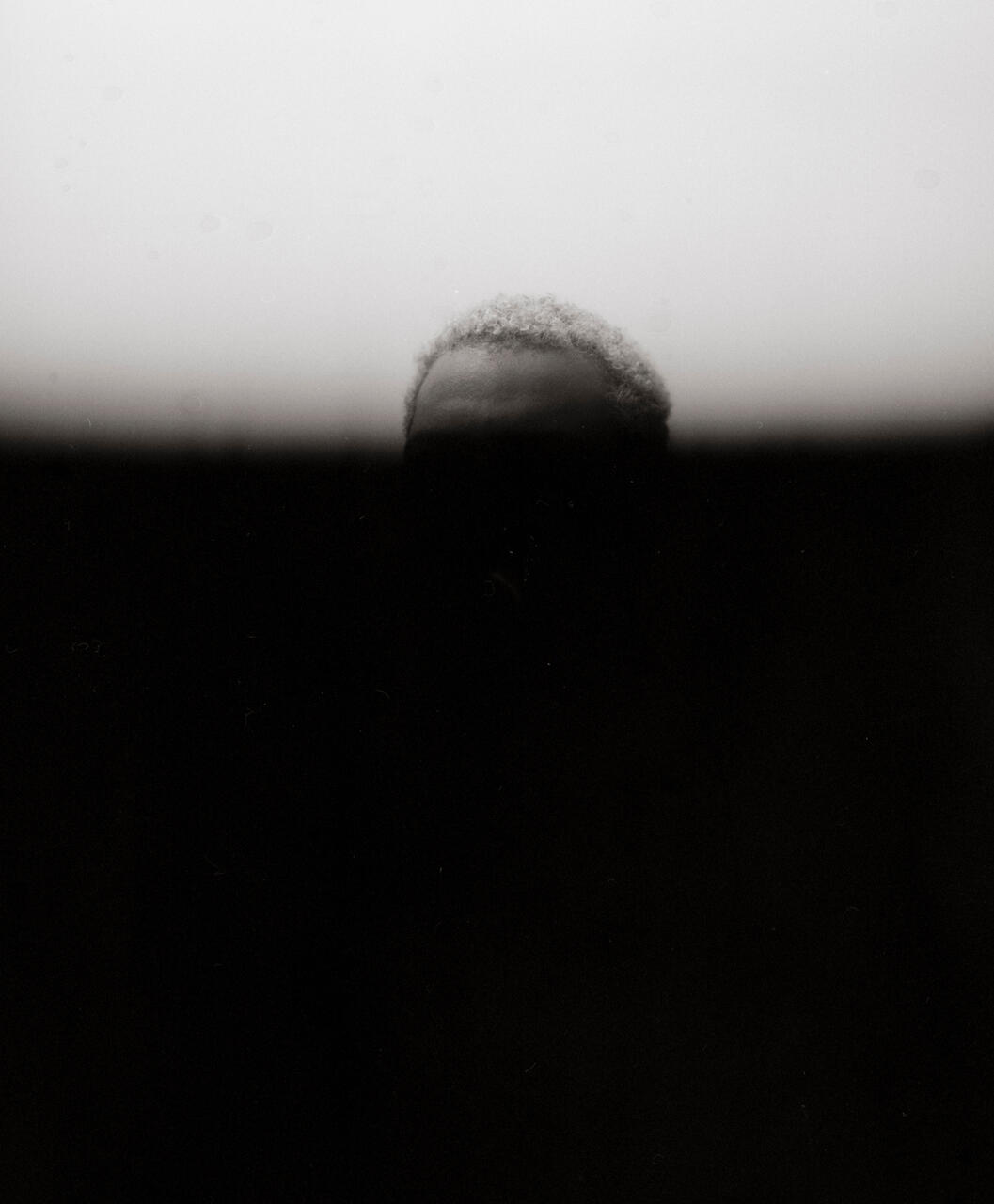Portrait of a person with a black gradient