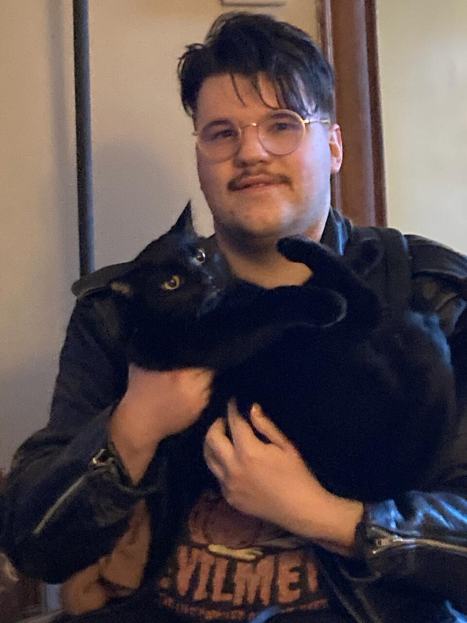 Portrait of Skylar Bull Lyon with his cat