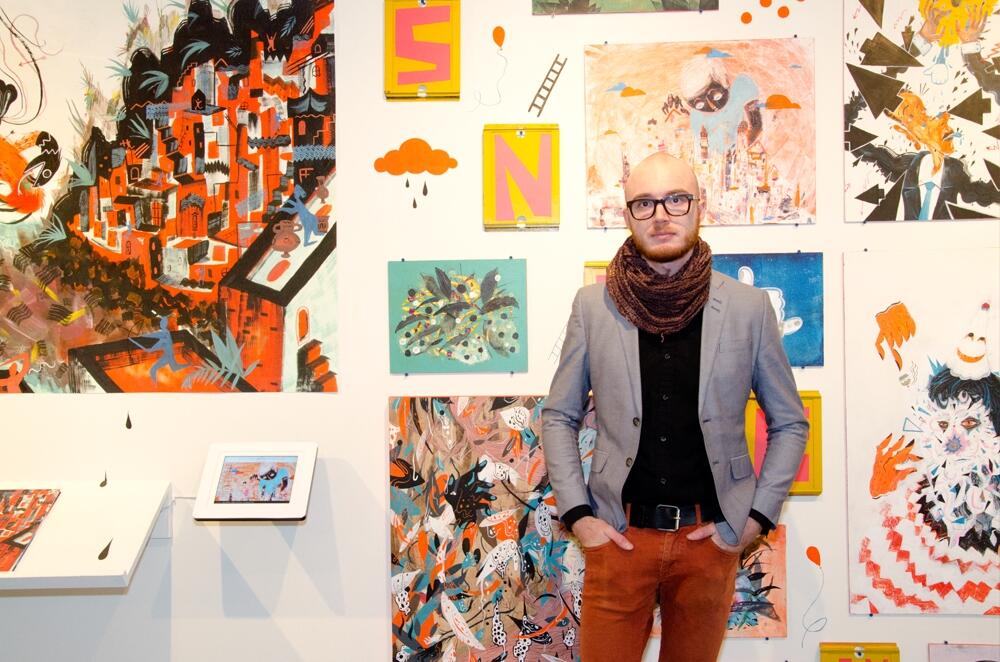 MCAD graduate Jake Herrick with commencement display
