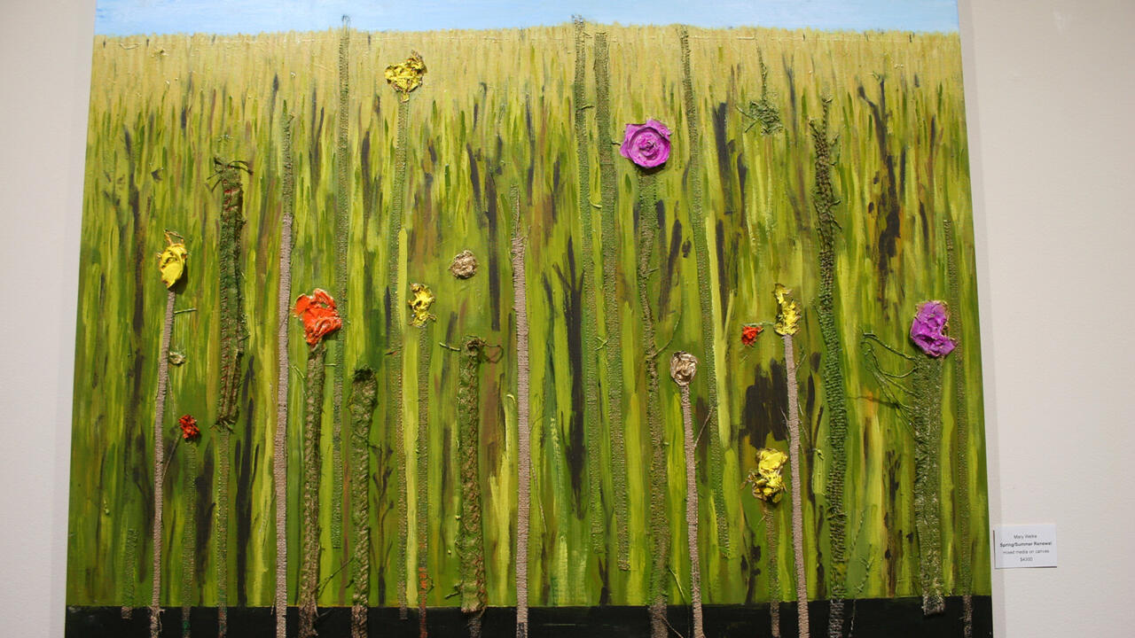 A textured acrylic painting of a field of tall large grass with several thick textured colorful flowers decorating the grasses
