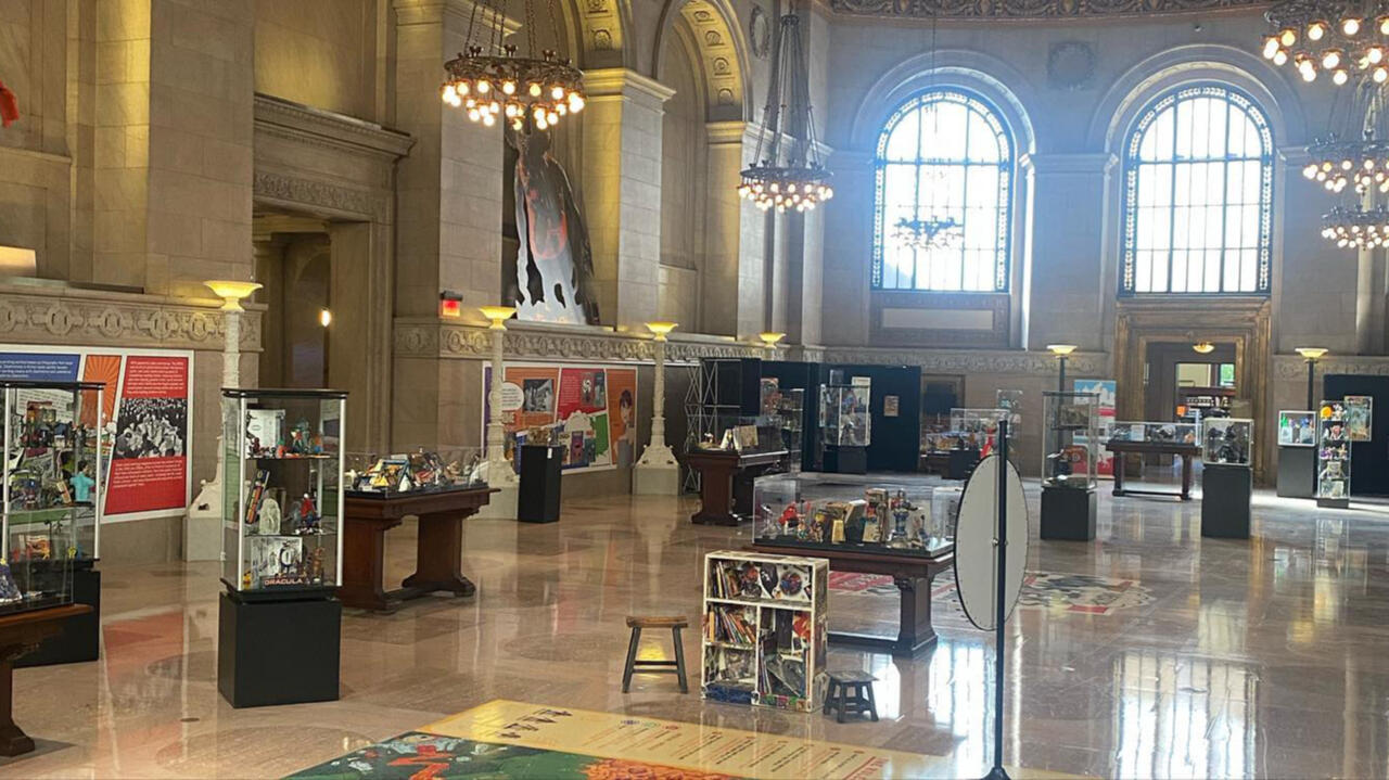 A large ornate hall filled with different superhero and comic book memorabilia 