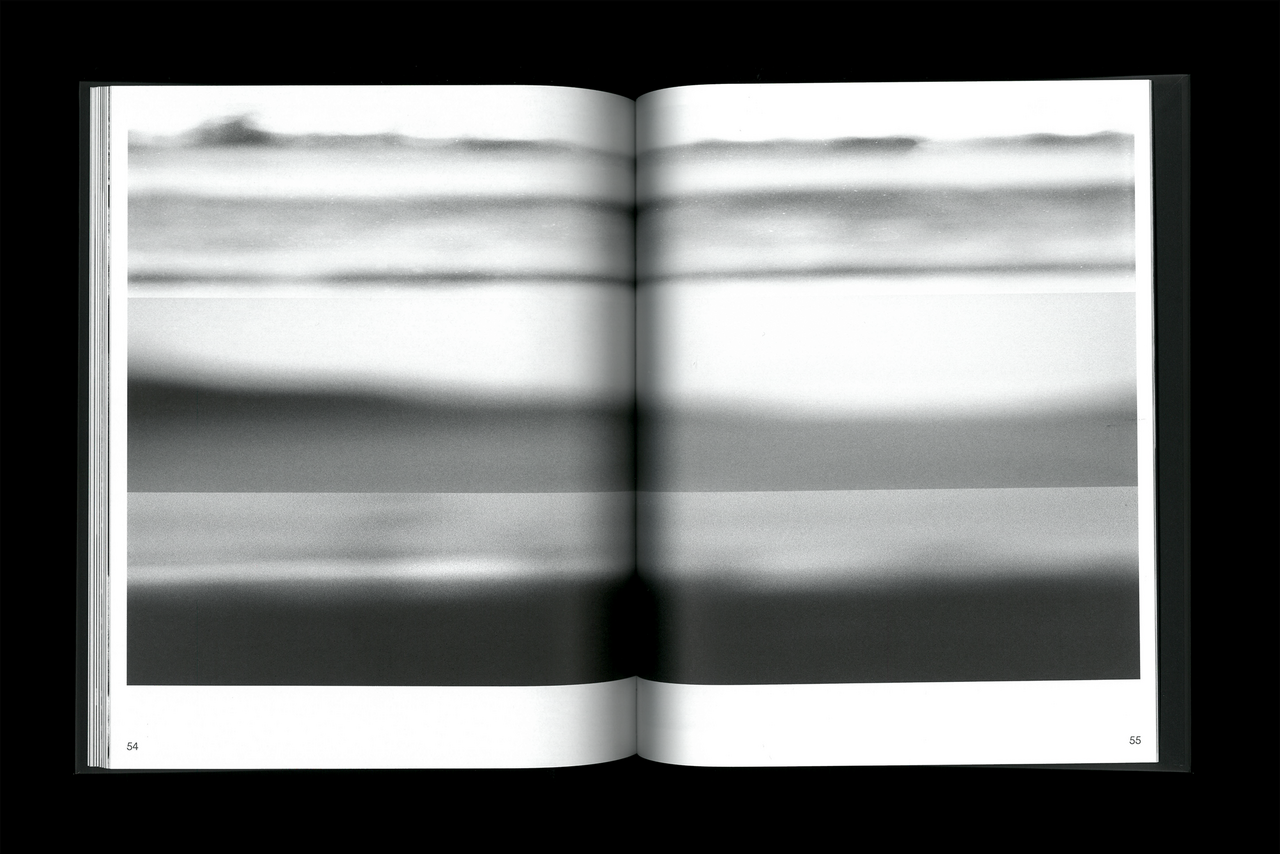 An image of an open book displaying a distorted camera image on both pages, as seen on a black background.