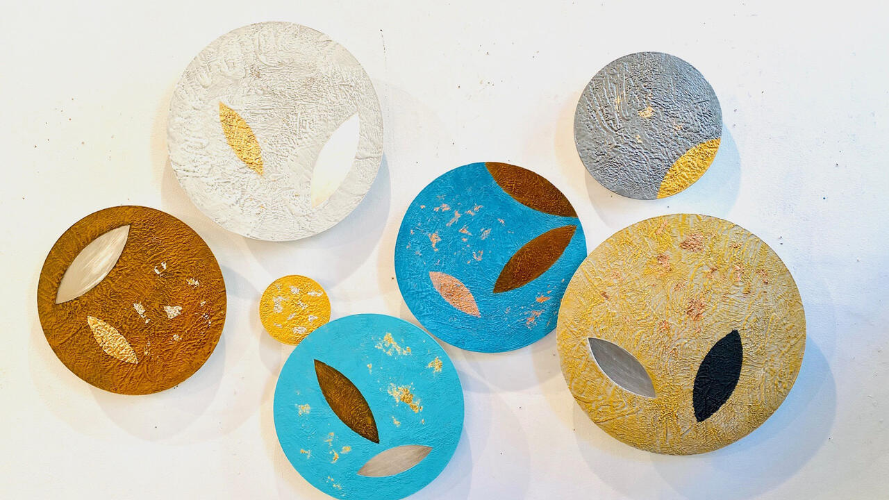 Colorful disks painted with different rotund leaf like shapes