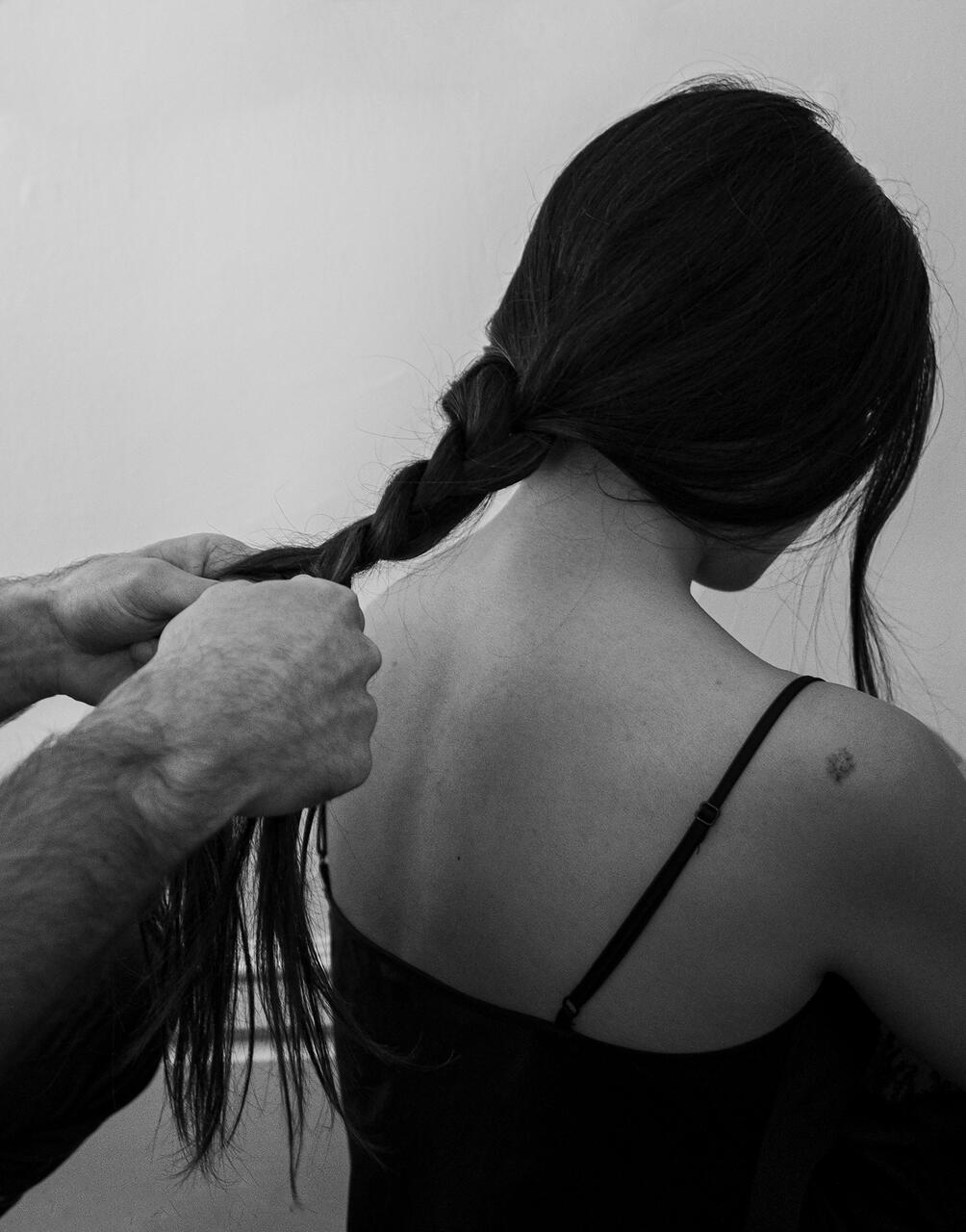 Photo of a person having their hair braided