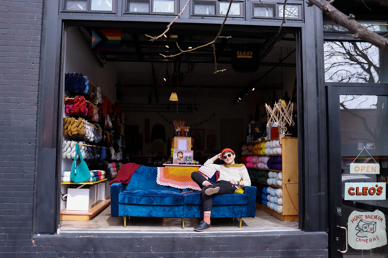 An image of Cleo Malone at their new yarn shop, Cleo's Yarn Shop, in Brooklyn, NY.