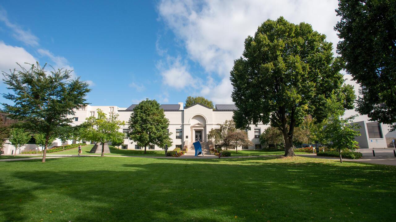 MCAD campus during the summer with a green lawn and a blue sky