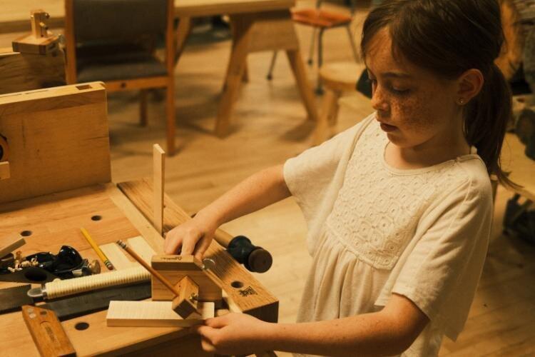 A child woodworking at Saint Maud's.