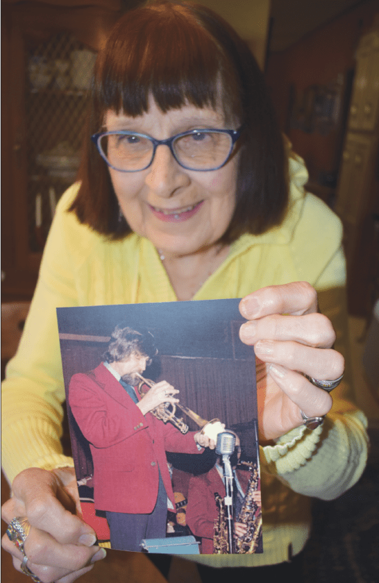 Joyce Reese Holding up a photo of her late Husband and muscian Keith Reese.