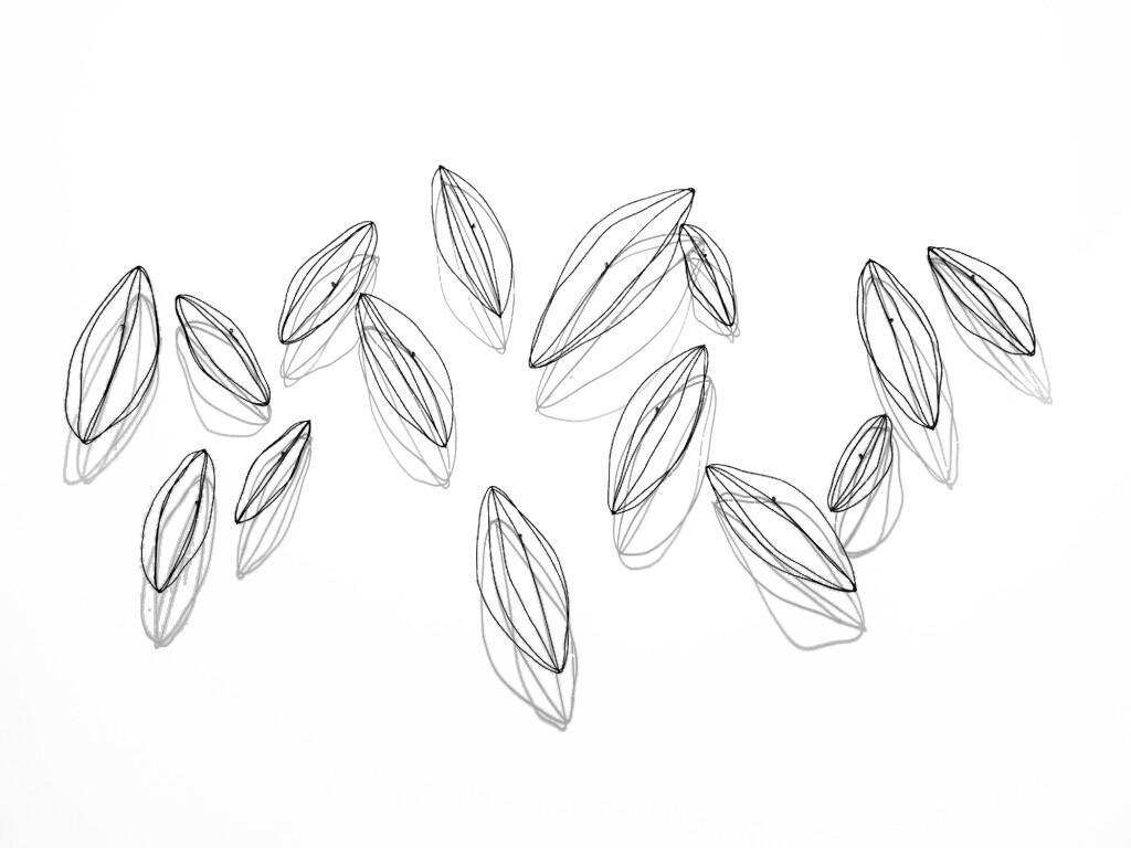 Scattered Seeds by Jodi Reeb. A wire wall sculpture of scattered seeds.