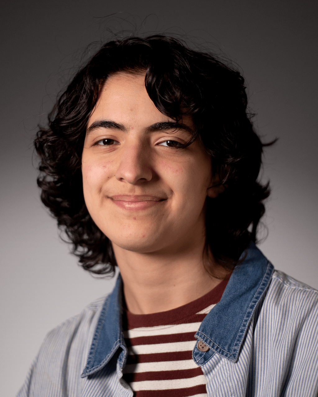Headshot of Aziz Kuhn.