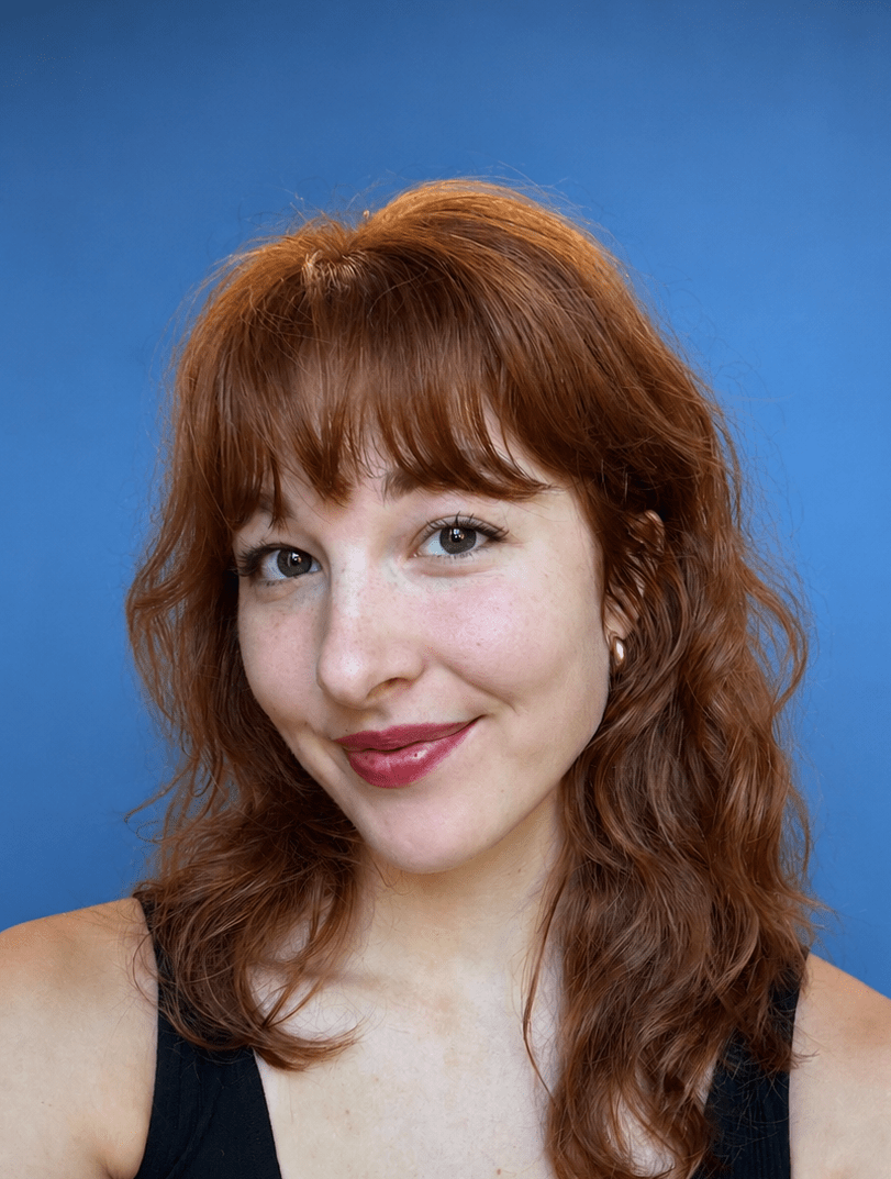 Photo of Clare Rollinger in front of a blue background.