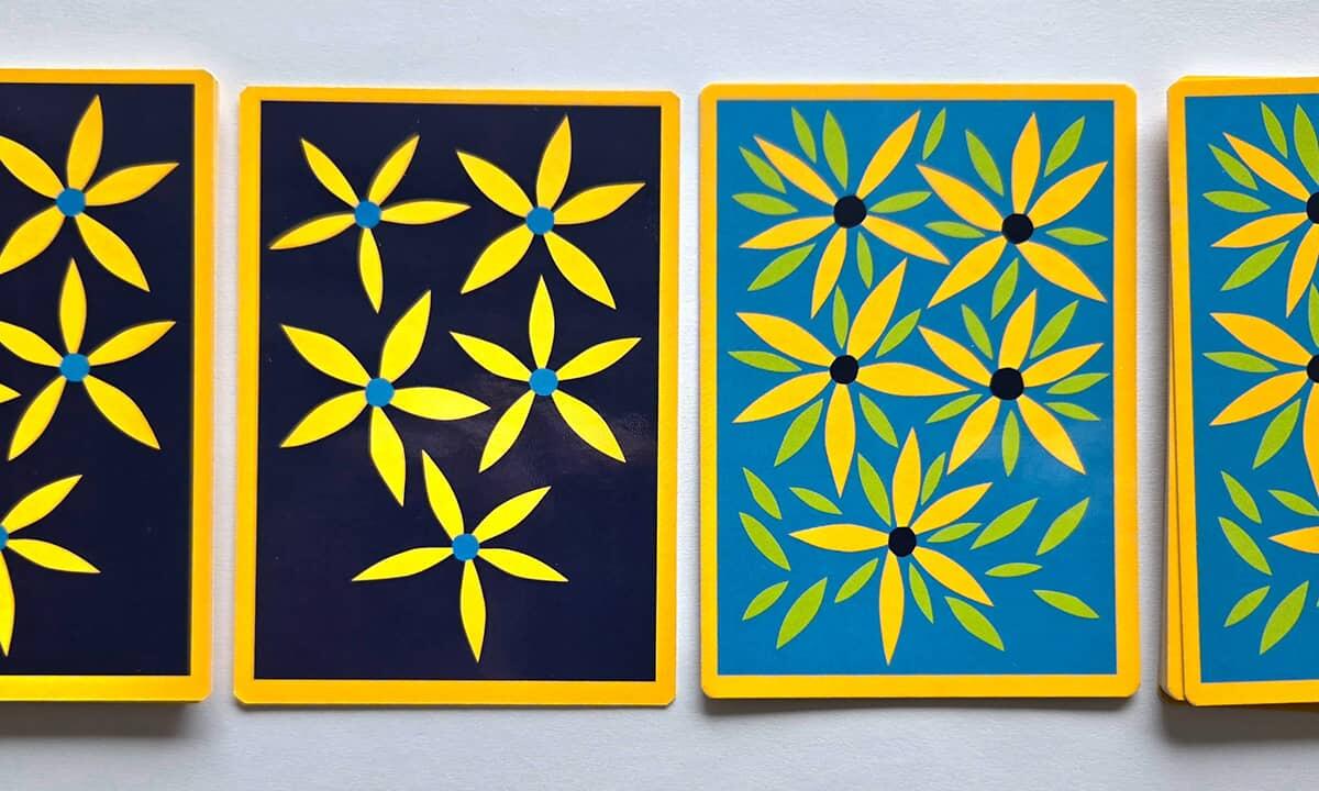 Papercut postcards of daises in the Columbia Heights school colors of blue and gold.