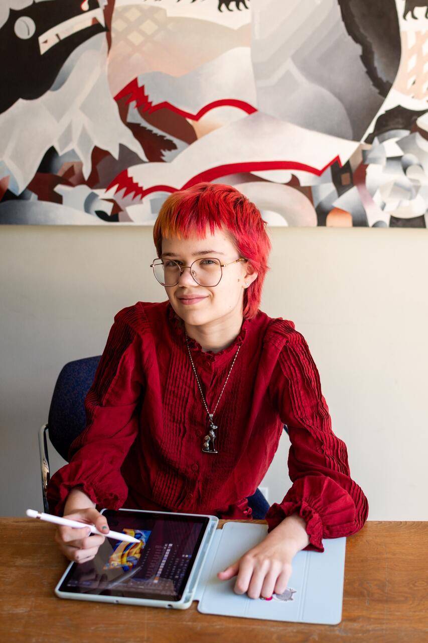 Brenna Swanson in the MCAD library with their designs