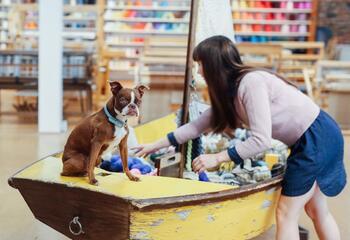 Cleo Malone with dog at Castaway Yarn Shop.