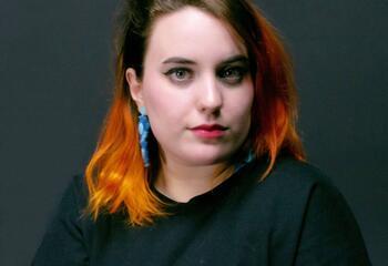 Headshot of Carly Poulsom.